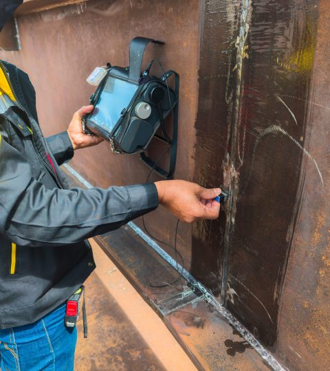 inspectors are checking defects in welded steel h beam add joint with process ultrasonic testing (ut) of non destructive testing(ndt)